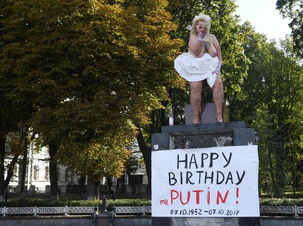 Una activista de Femen, parodiando a Marilyn Monroe, cantaó ayer el 'happy birthday» a Putin, en Kiev. :: S. S. / afp/